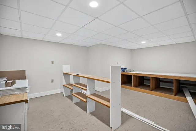 a view of an empty room with wooden floor and closet