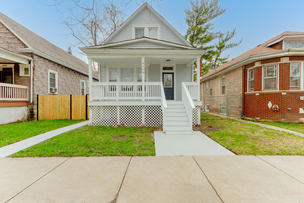 a front view of a house with a garden