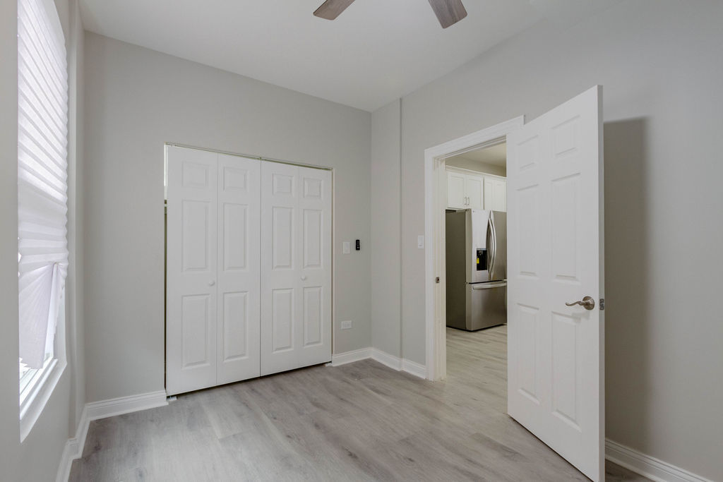 8538 South May Street Chicago, IL 60620 - Photo 13 of 38 a view of a utility room with closet and wooden floor