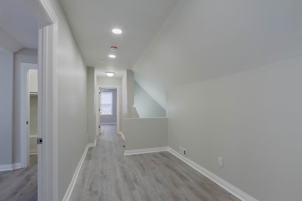 8538 South May Street Chicago, IL 60620 - Photo 20 of 38 a view of a hallway with wooden floor