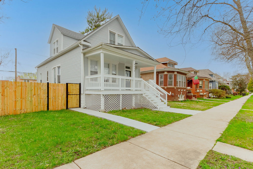 8538 South May Street Chicago, IL 60620 - Photo 2 of 38 a front view of a house with a yard and potted plants