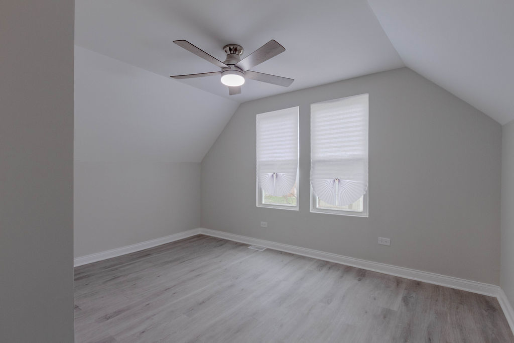 8538 South May Street Chicago, IL 60620 - Photo 22 of 38 an empty room with wooden floor fan and windows