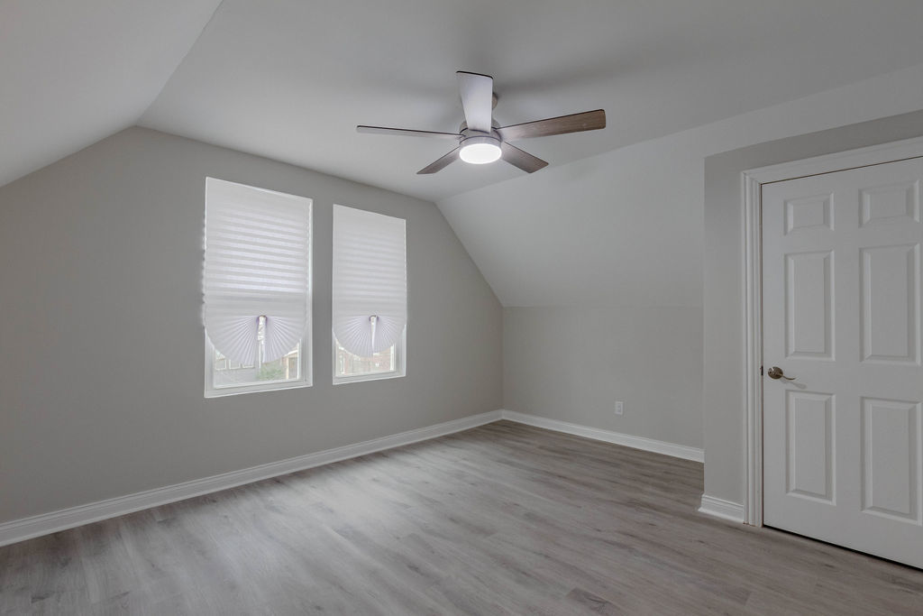 8538 South May Street Chicago, IL 60620 - Photo 26 of 38 an empty room with wooden floor ceiling fan and windows