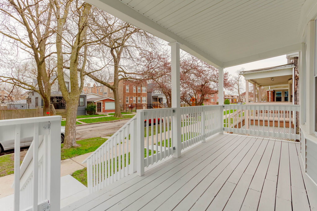 8538 South May Street Chicago, IL 60620 - Photo 3 of 38 a view of a balcony with wooden floor and fence