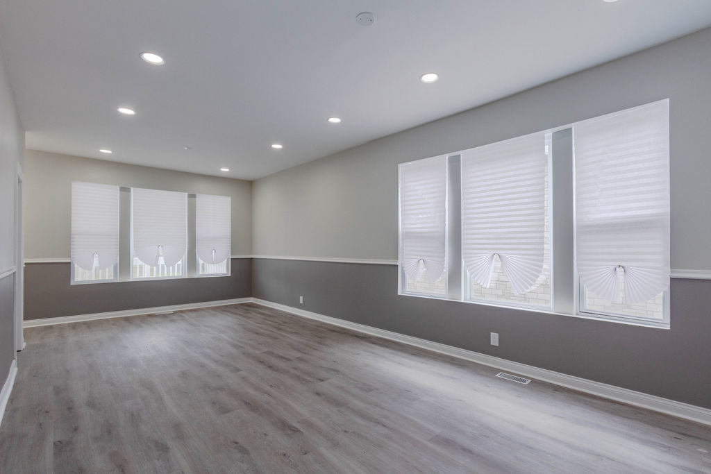 8538 South May Street Chicago, IL 60620 - Photo 7 of 38 a view of an empty room with wooden floor and a window