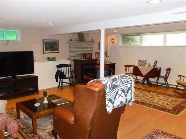 33 Red Bridge Road Wilbraham, MA 01095 - Photo 16 of 21 a living room with furniture a flat screen tv and a fireplace