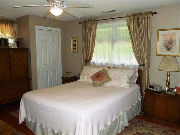 33 Red Bridge Road Wilbraham, MA 01095 - Photo 9 of 21 a bedroom with a bed and a chandelier