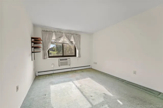 an empty room with windows and entrance