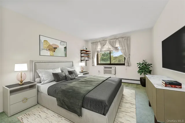 a bedroom with bed and a flat screen tv