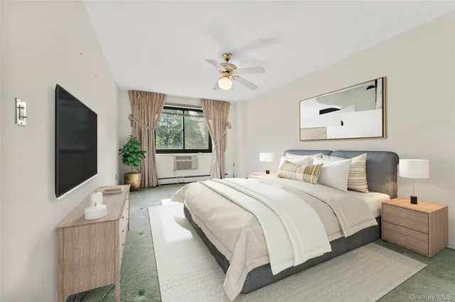 a spacious bedroom with a bed and a flat screen tv