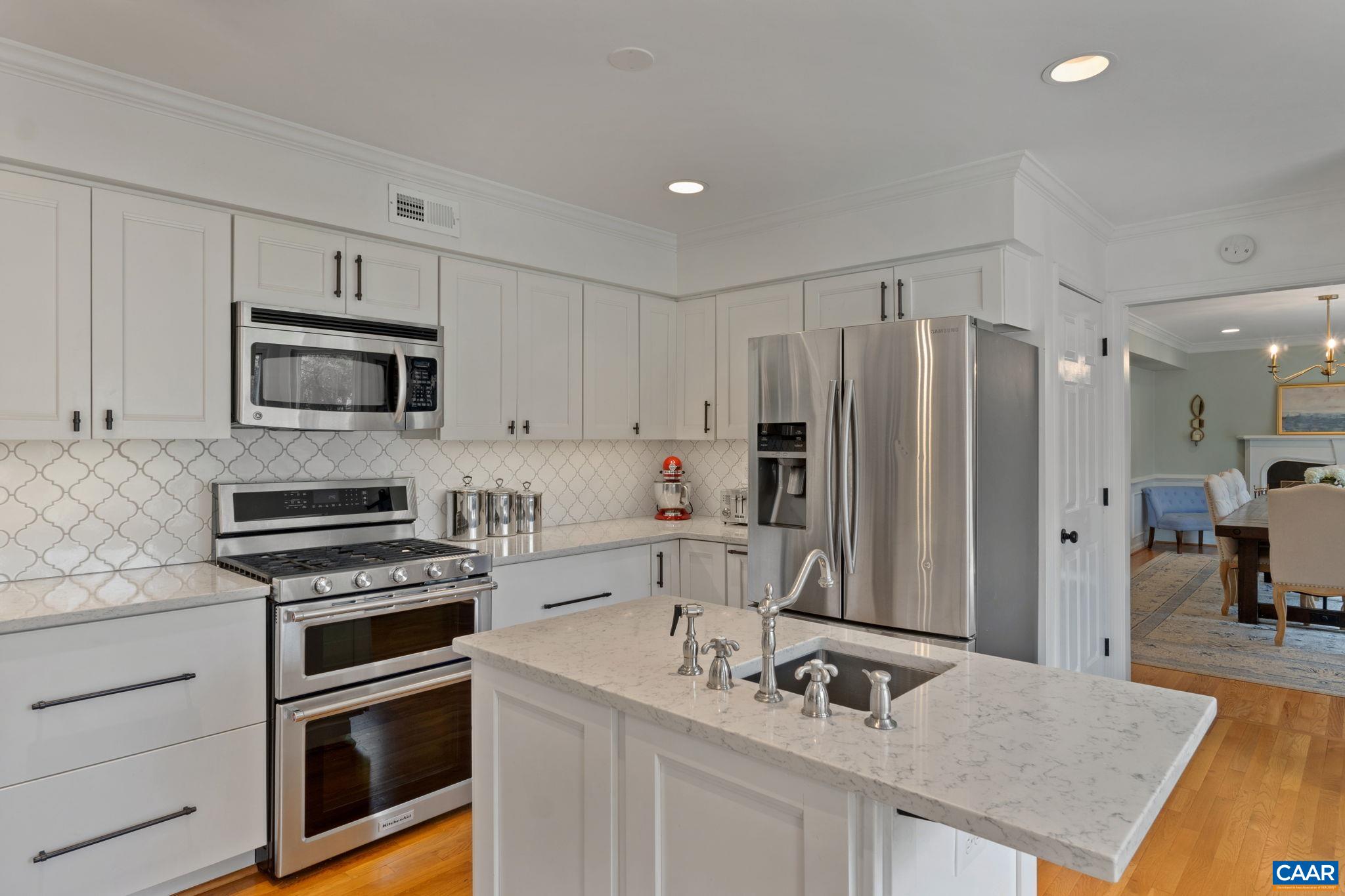 2603 Holkham Drive Charlottesville, VA 22901 - Photo 22 of 60 a kitchen with kitchen island granite countertop a sink appliances and cabinets
