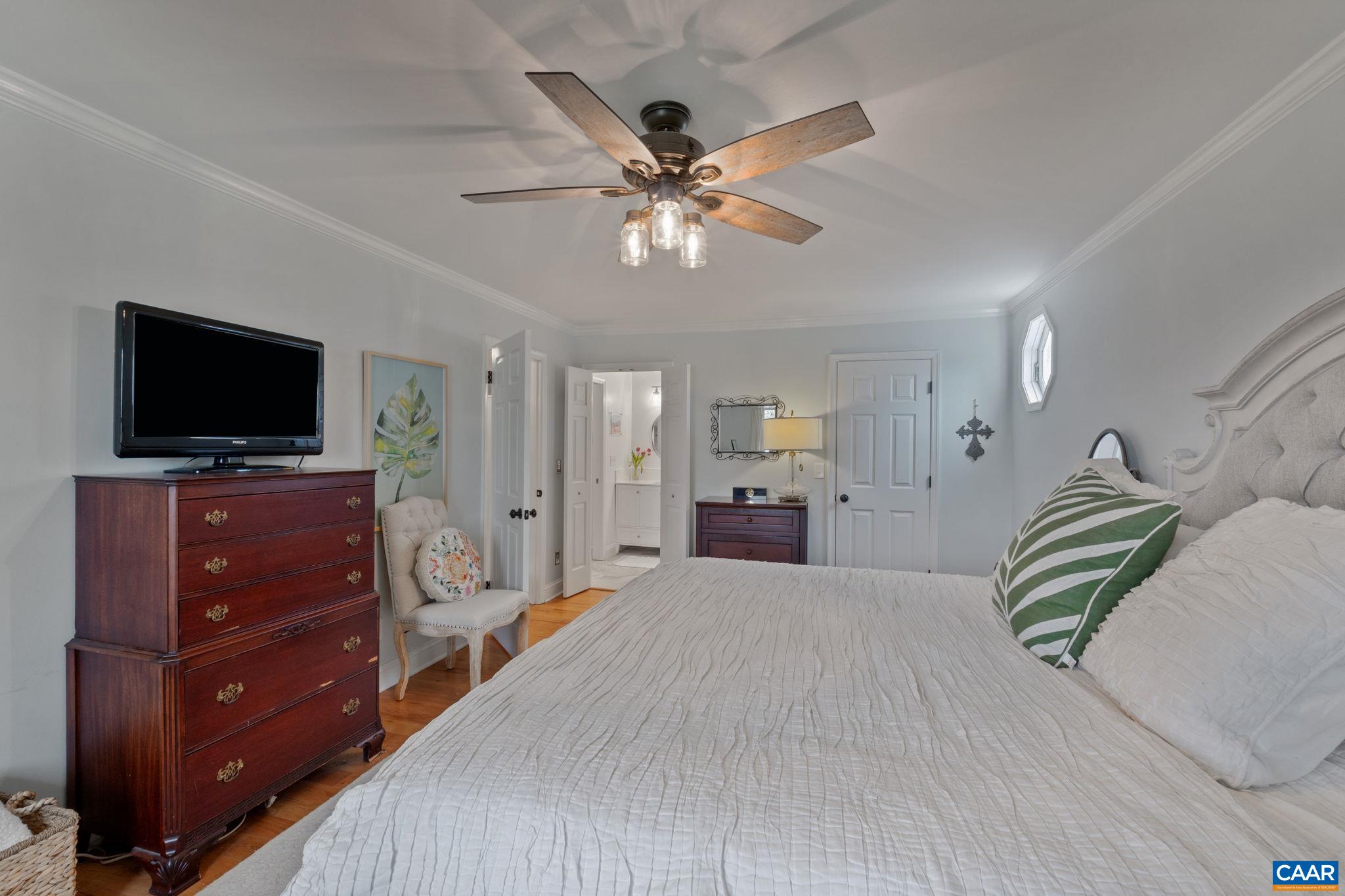 2603 Holkham Drive Charlottesville, VA 22901 - Photo 34 of 60 a bedroom with a bed and a flat screen tv
