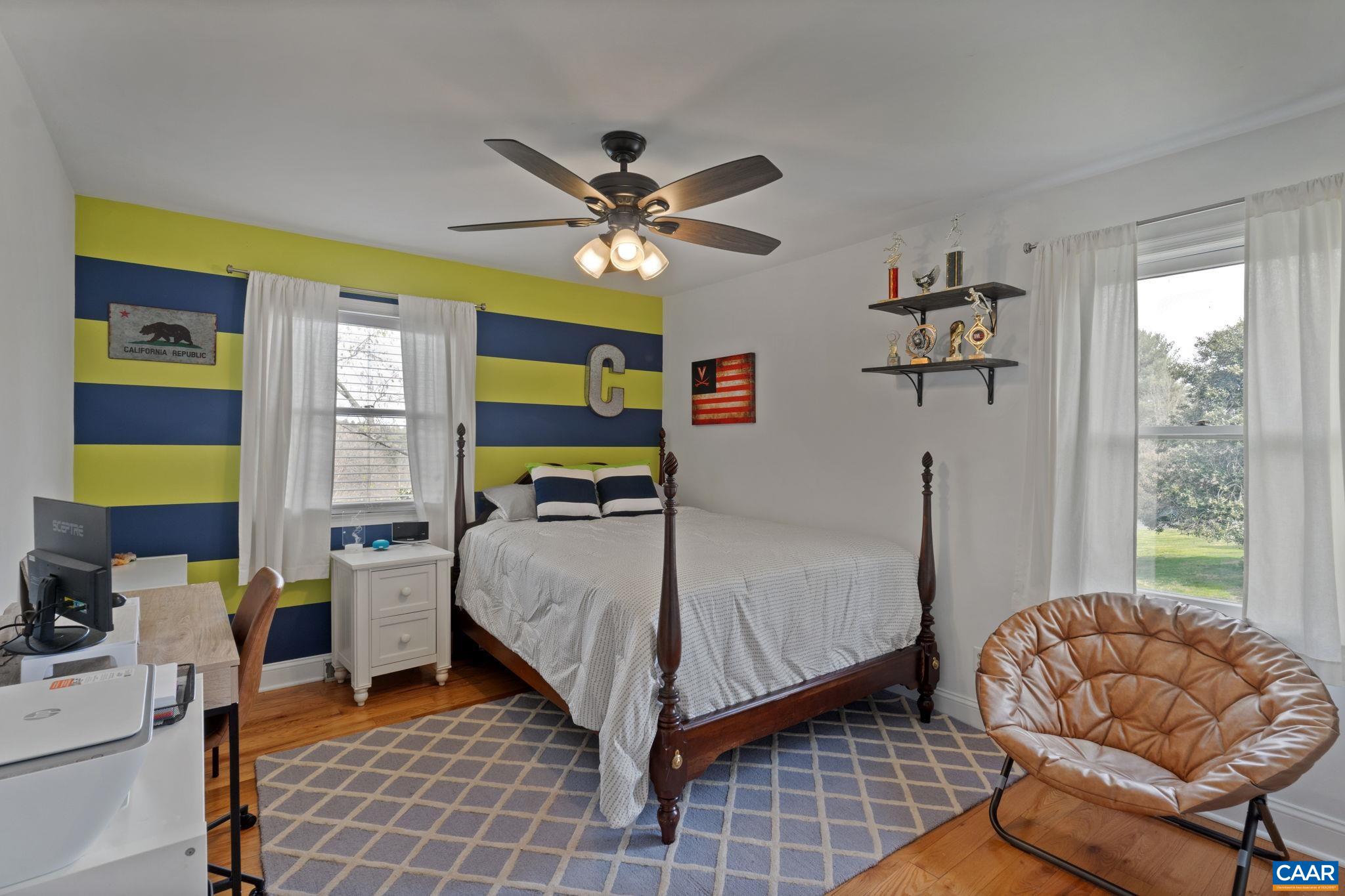 2603 Holkham Drive Charlottesville, VA 22901 - Photo 40 of 60 a bedroom with a bed and a chandelier