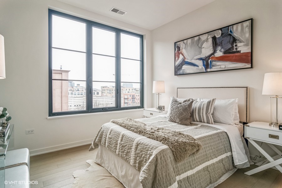 1400 West Monroe Street, Unit 6E Chicago, IL 60607 - Photo 12 of 12 a bedroom with a bed painting on the wall and a window