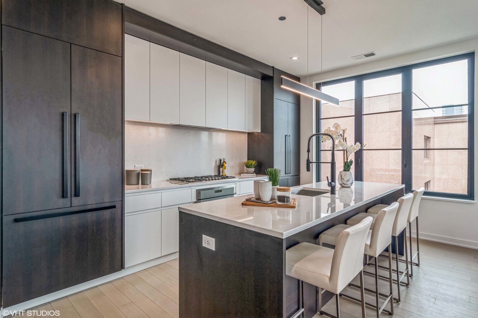 1400 West Monroe Street, Unit 6E Chicago, IL 60607 - Photo 3 of 12 a kitchen with a table chairs refrigerator and cabinets