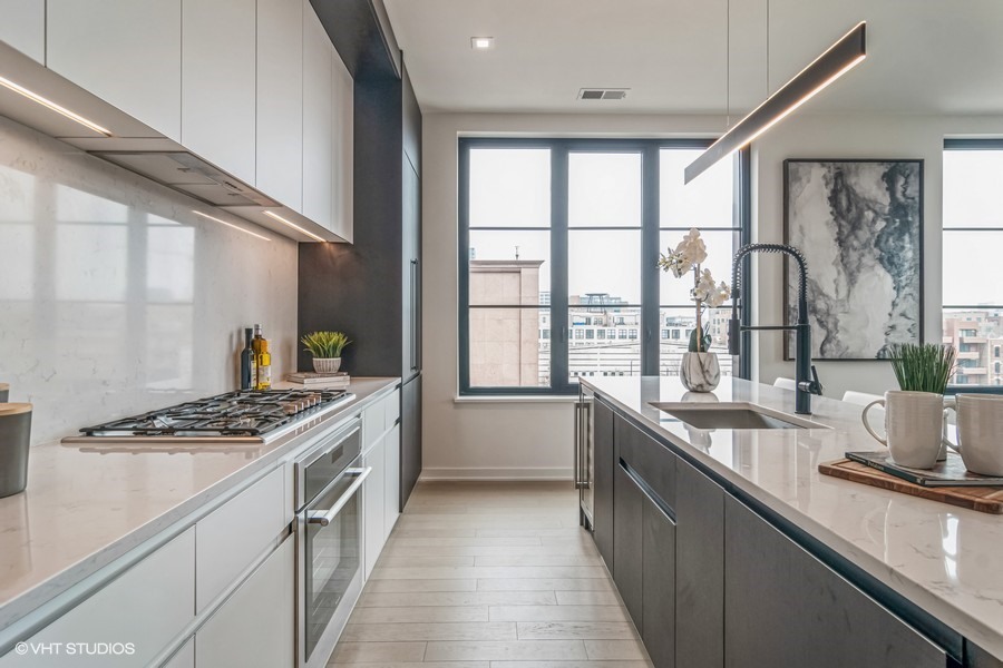 1400 West Monroe Street, Unit 6E Chicago, IL 60607 - Photo 4 of 12 a kitchen with granite countertop a stove and a sink