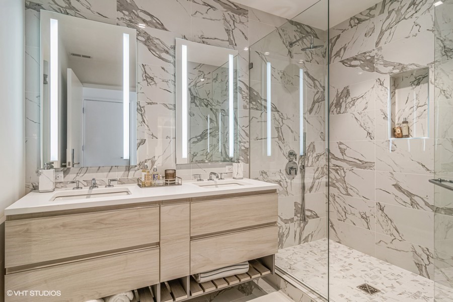 1400 West Monroe Street, Unit 6E Chicago, IL 60607 - Photo 10 of 12 a bathroom with a double vanity sink mirror and shower