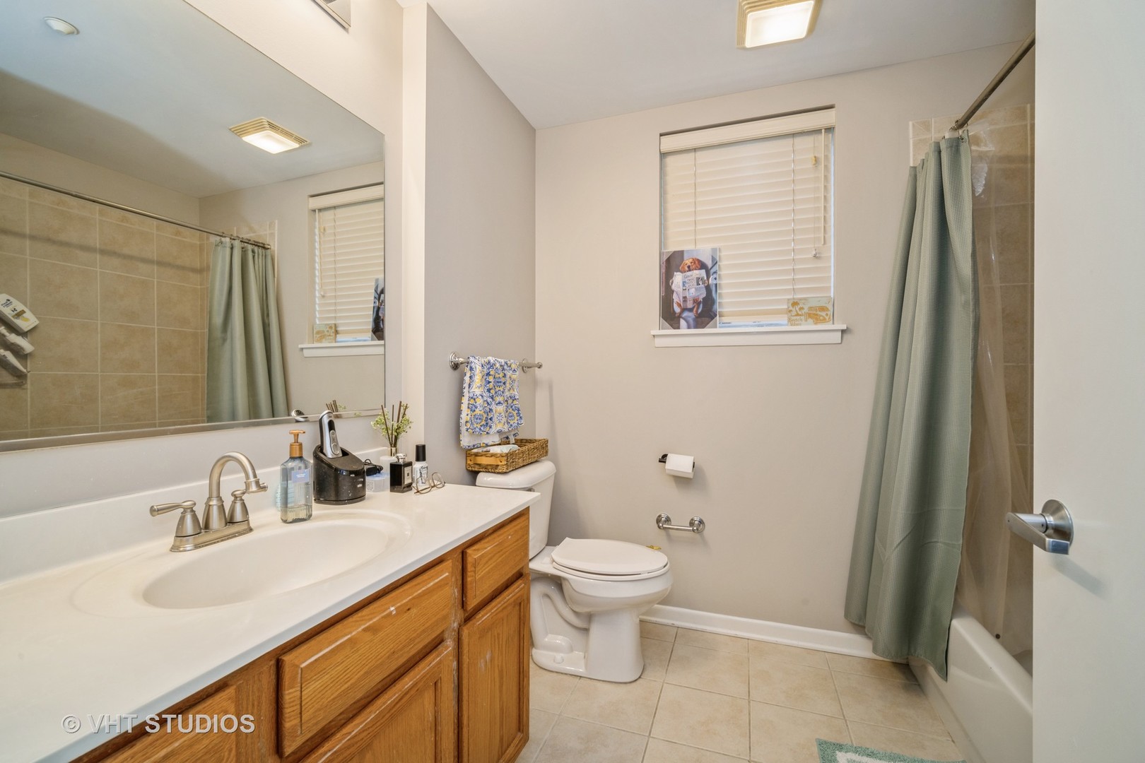 720 Prestwick Lane, Unit 307 Wheeling, IL 60090 - Photo 7 of 10 a bathroom with a double vanity sink toilet and a mirror