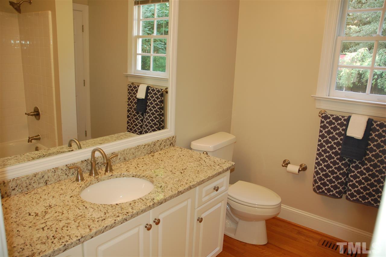10900 Fitzwilliam Street Raleigh, NC 27614 - Photo 13 of 25 a bathroom with a granite countertop toilet sink and mirror