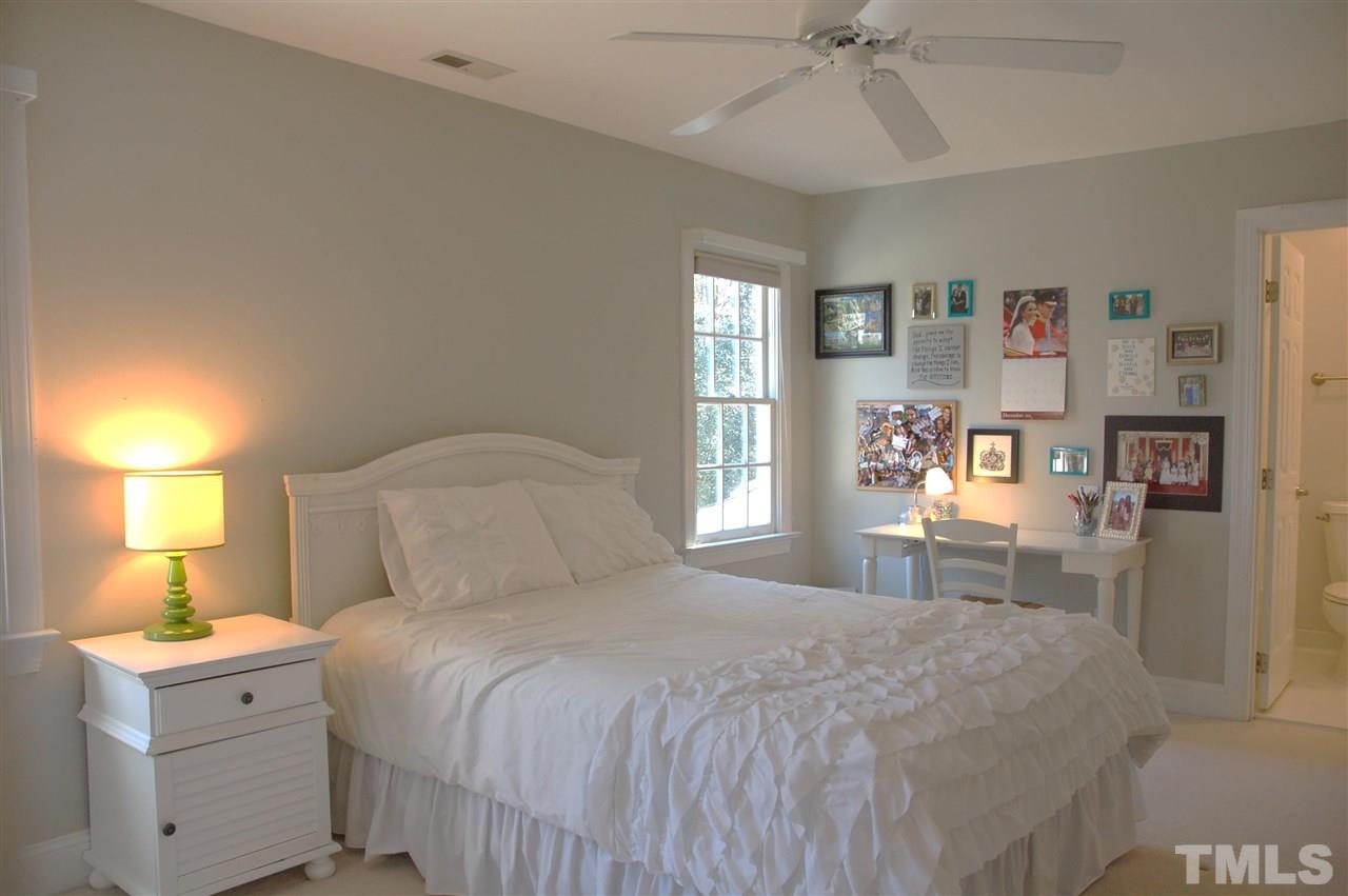 10900 Fitzwilliam Street Raleigh, NC 27614 - Photo 14 of 25 a bedroom with a bed and a chandelier