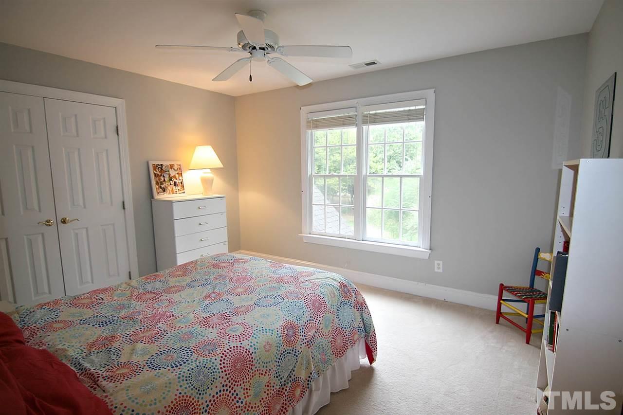 10900 Fitzwilliam Street Raleigh, NC 27614 - Photo 16 of 25 a bedroom with a bed closet and a window