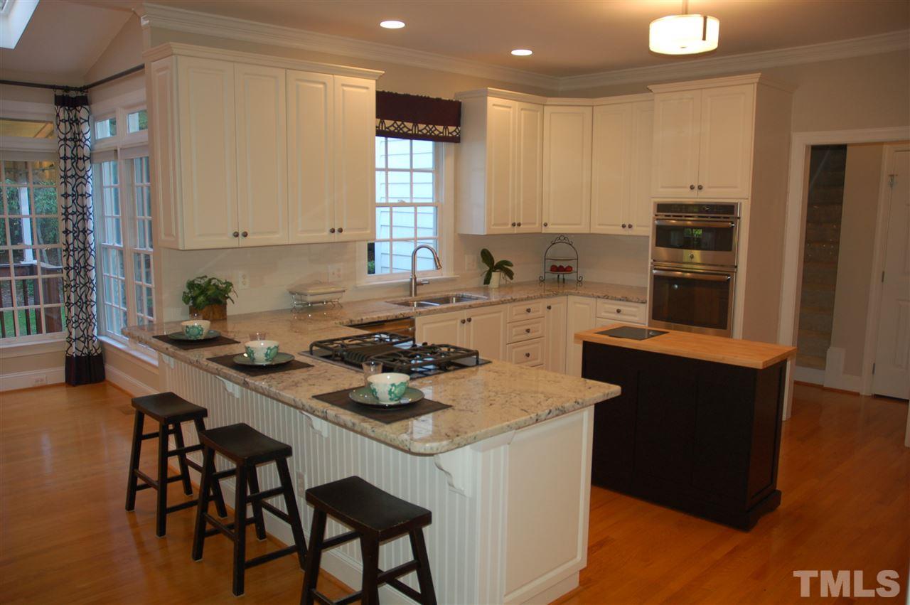 10900 Fitzwilliam Street Raleigh, NC 27614 - Photo 3 of 25 a kitchen with a sink a stove a refrigerator and wooden floor