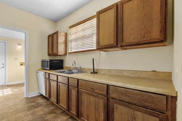 a kitchen with stainless steel appliances granite countertop a sink and a cabinets