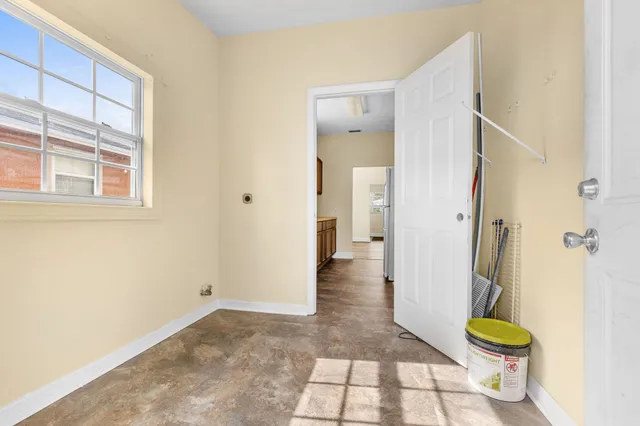 a view of a hallway with wooden floor and a glass door