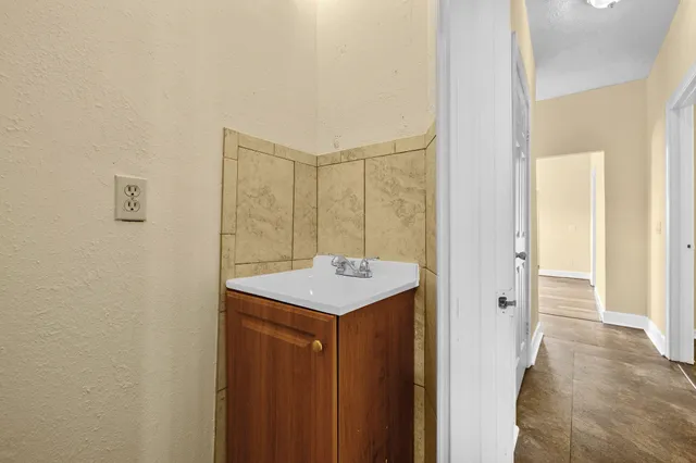 a bathroom with a sink mirror and shower