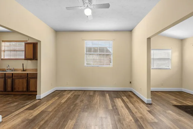 wooden floor in an empty room with a window