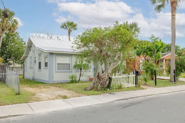 a house that has a tree in front of it