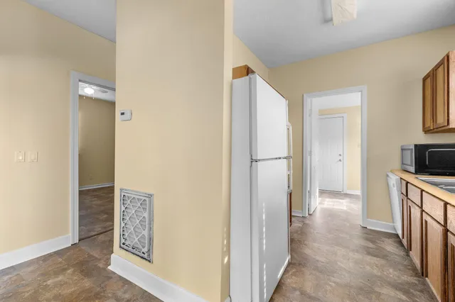 a view of hallway with cabinets and a hallway