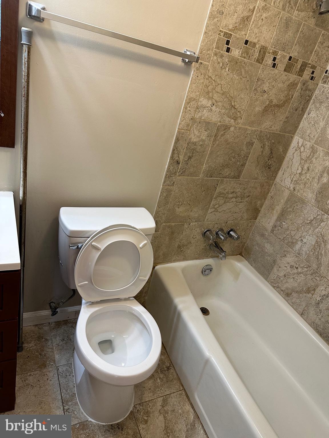 1805 Addison Road South District Heights, MD 20747 - Photo 15 of 28 a white toilet sitting next to a bath tub