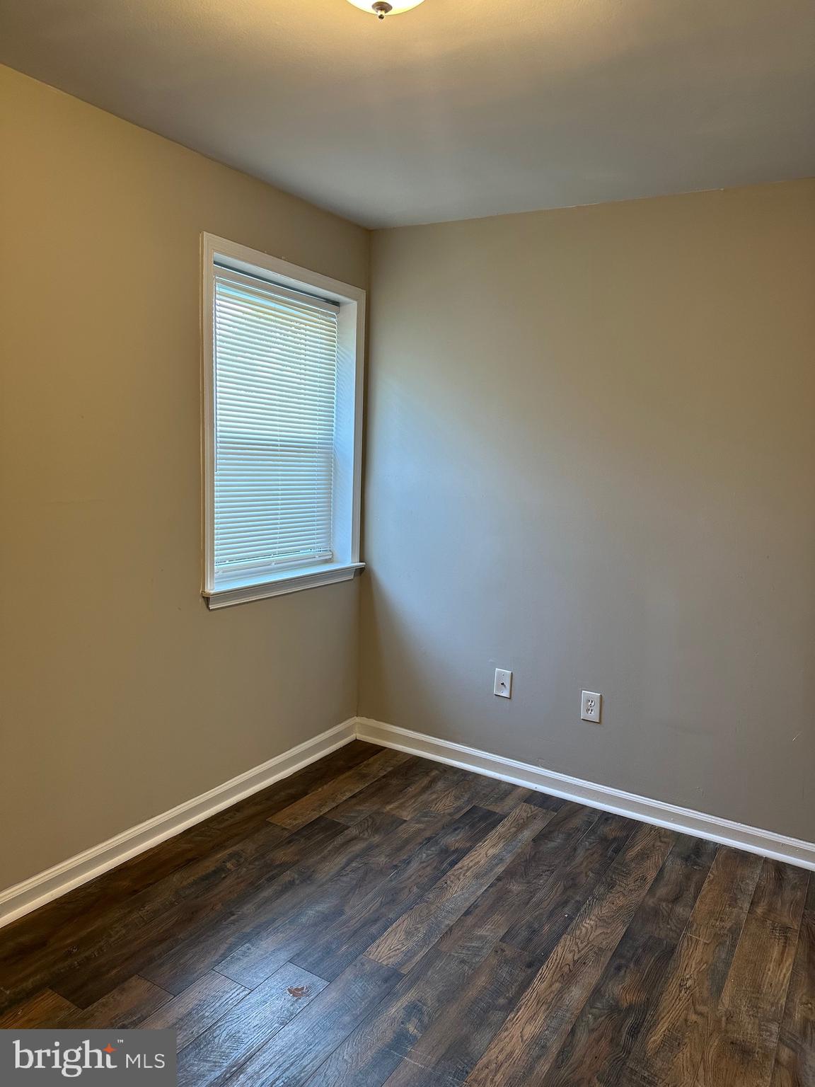 1805 Addison Road South District Heights, MD 20747 - Photo 17 of 28 a view of an empty room with wooden floor and a window