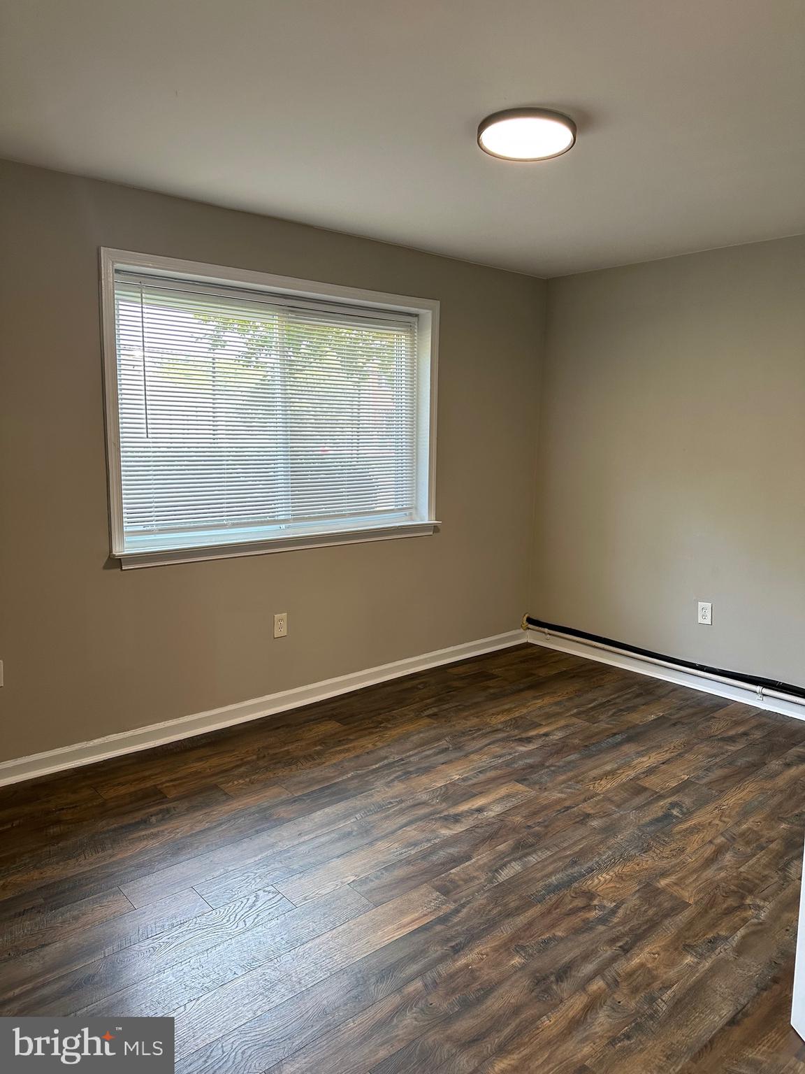 1805 Addison Road South District Heights, MD 20747 - Photo 20 of 28 a view of an empty room with wooden floor and a window