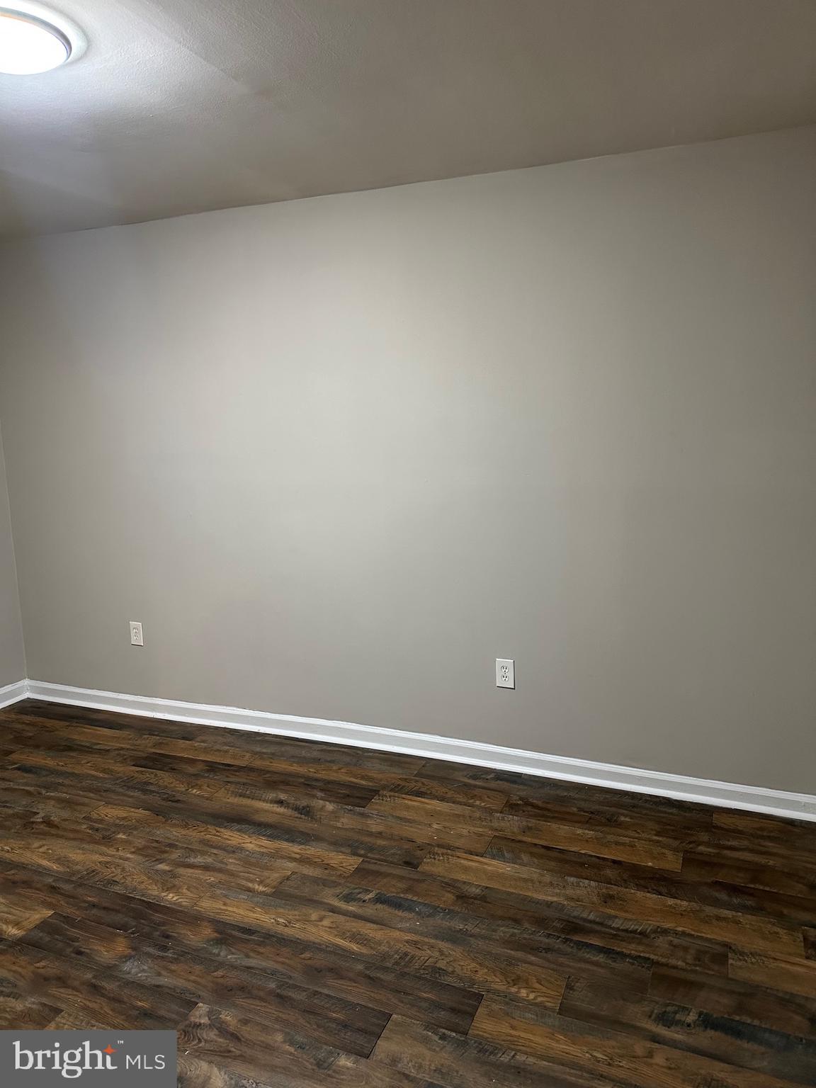 1805 Addison Road South District Heights, MD 20747 - Photo 27 of 28 a view of an empty room with wooden floor