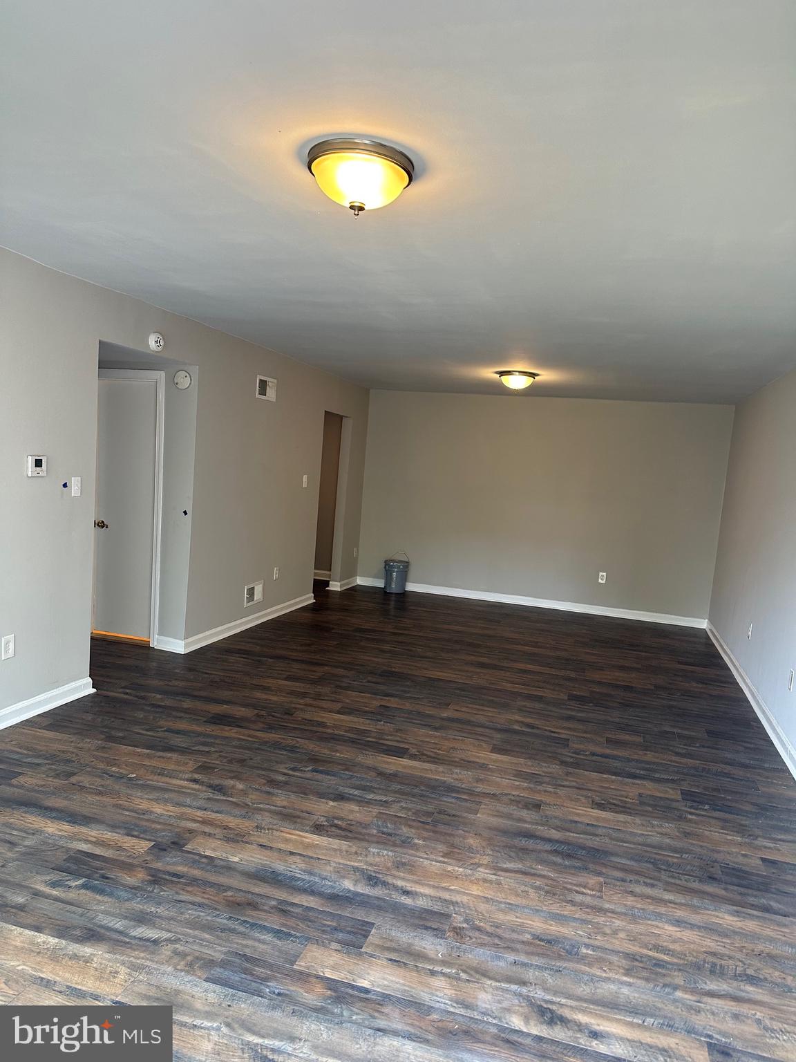 1805 Addison Road South District Heights, MD 20747 - Photo 4 of 28 an empty room with wooden floor and windows