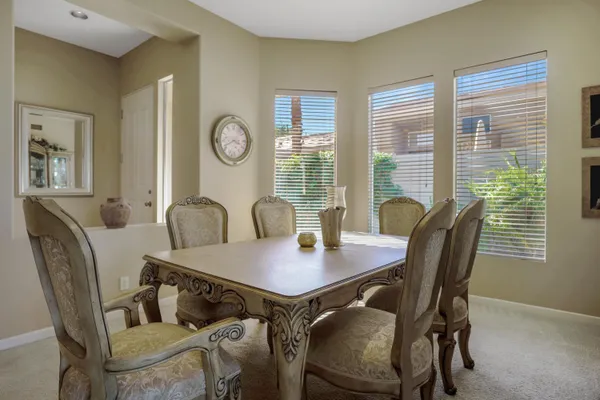 a view of a dining room with furniture and window