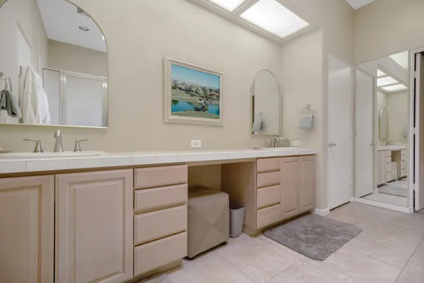 a spacious bathroom with a double vanity sink mirror and