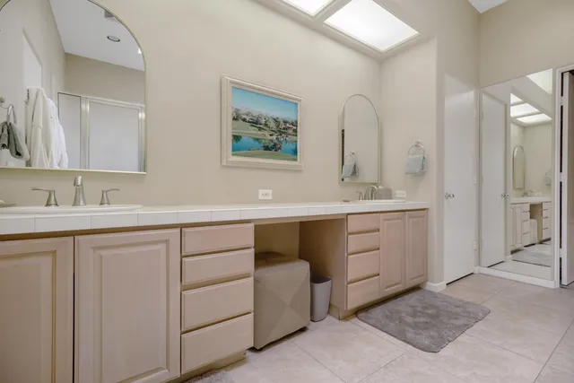 a spacious bathroom with a double vanity sink mirror and