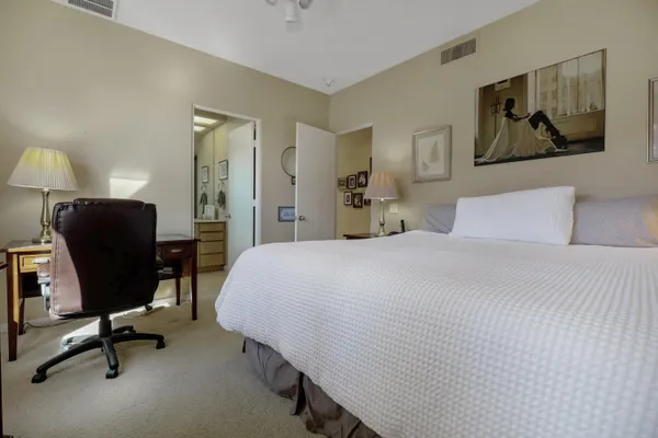 a bedroom with a bed and a desk