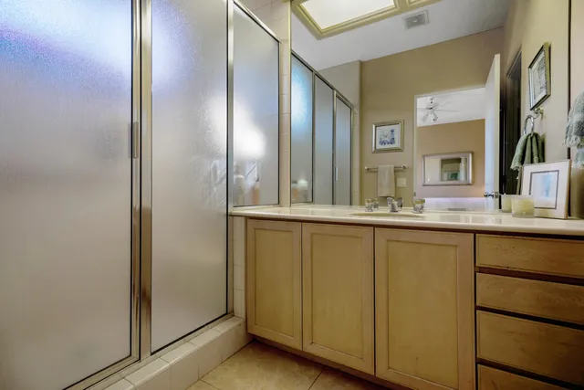a bathroom with a double vanity sink and a mirror