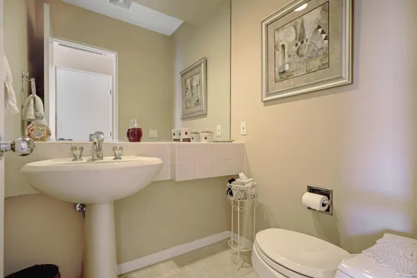a bathroom with a sink mirror and toilet