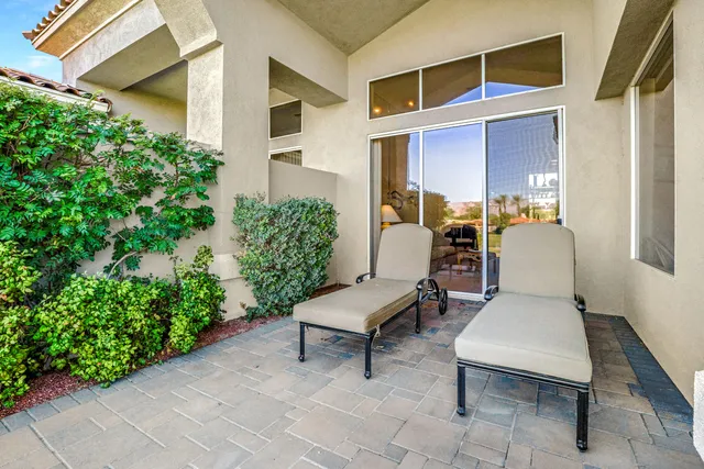 a view of a patio with chair and table and chairs