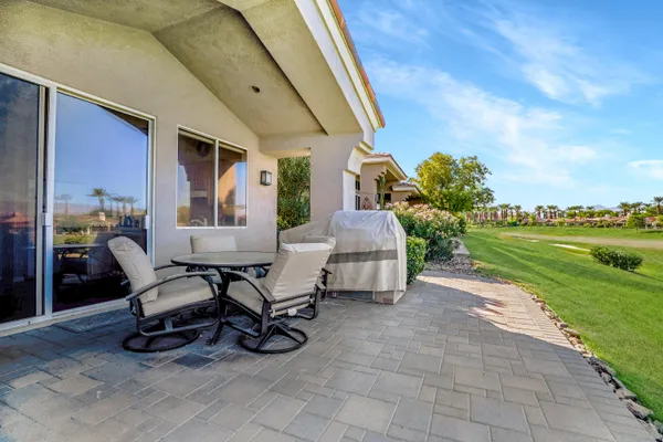 a building outdoor space with patio furniture and garden