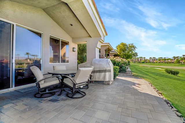 a building outdoor space with patio furniture and garden