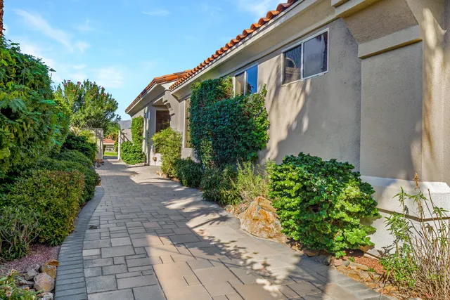 a front view of a house with a yard and flowers