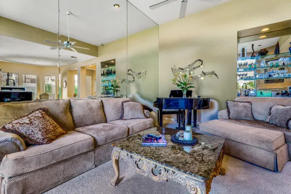 a living room with furniture and kitchen view