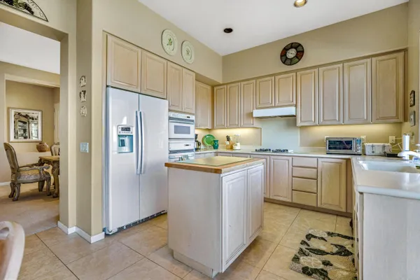 a kitchen with granite countertop a refrigerator and a sink