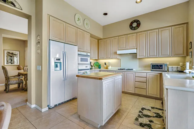 a kitchen with granite countertop a refrigerator and a sink